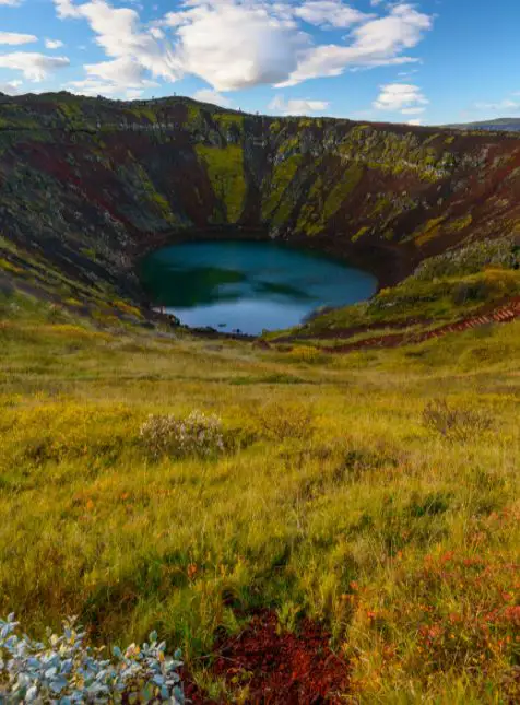Cratère volcanique Kerið avec lac turquoise entouré de parois colorées en Islande - voyage sur mesure en Islande Les Sens du Voyage
